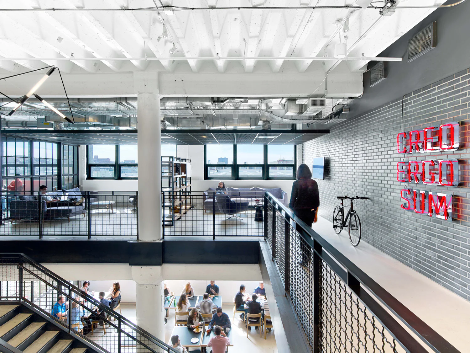 Mezzanine walkway inside the Foundry with a neon Creo Ergo Sum sign