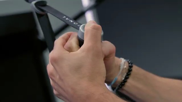 Close-up of hands on the Tonal handle during a golf-specific exercise