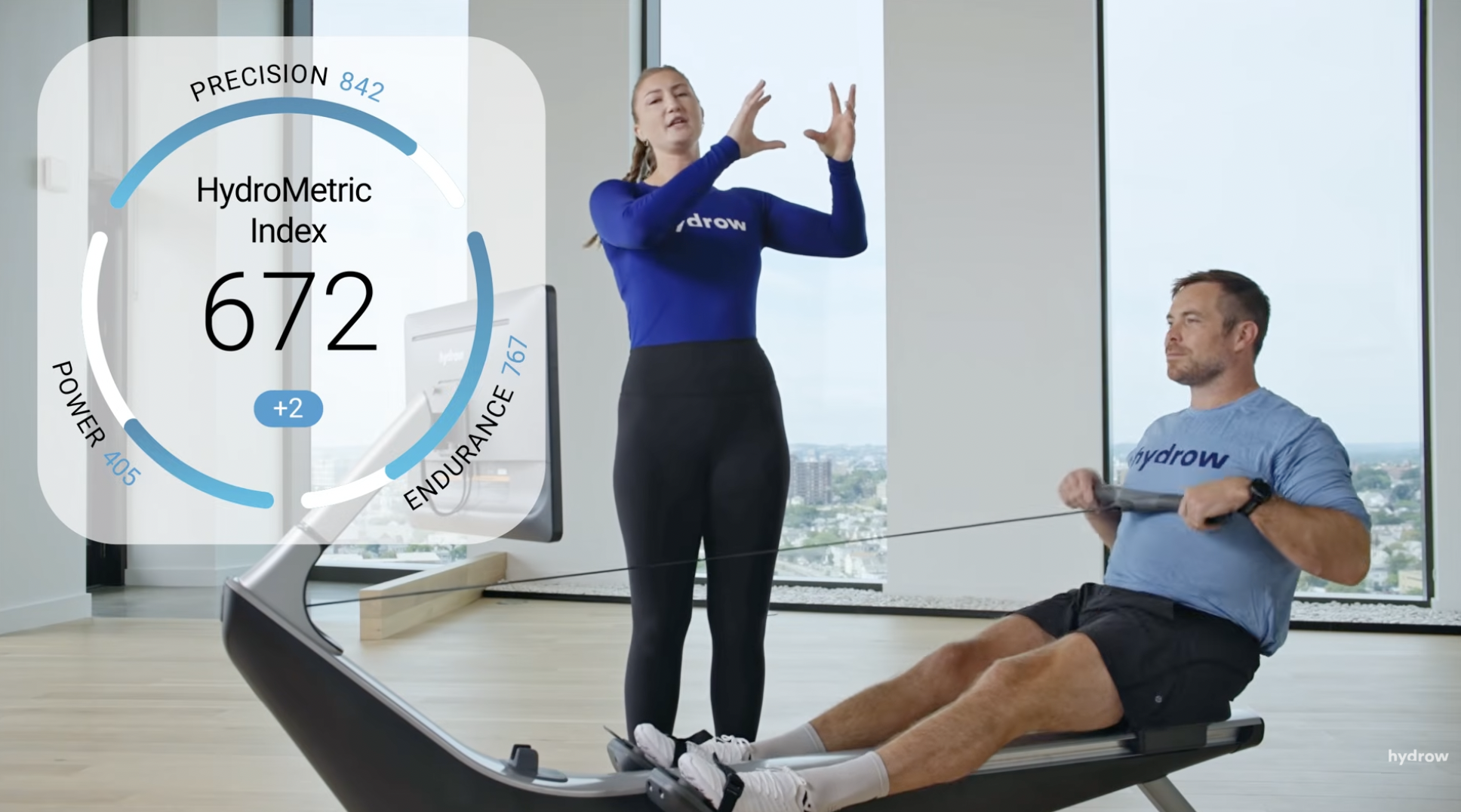 Trainer demonstrating the HydroMetrics overlay live during a rowing session