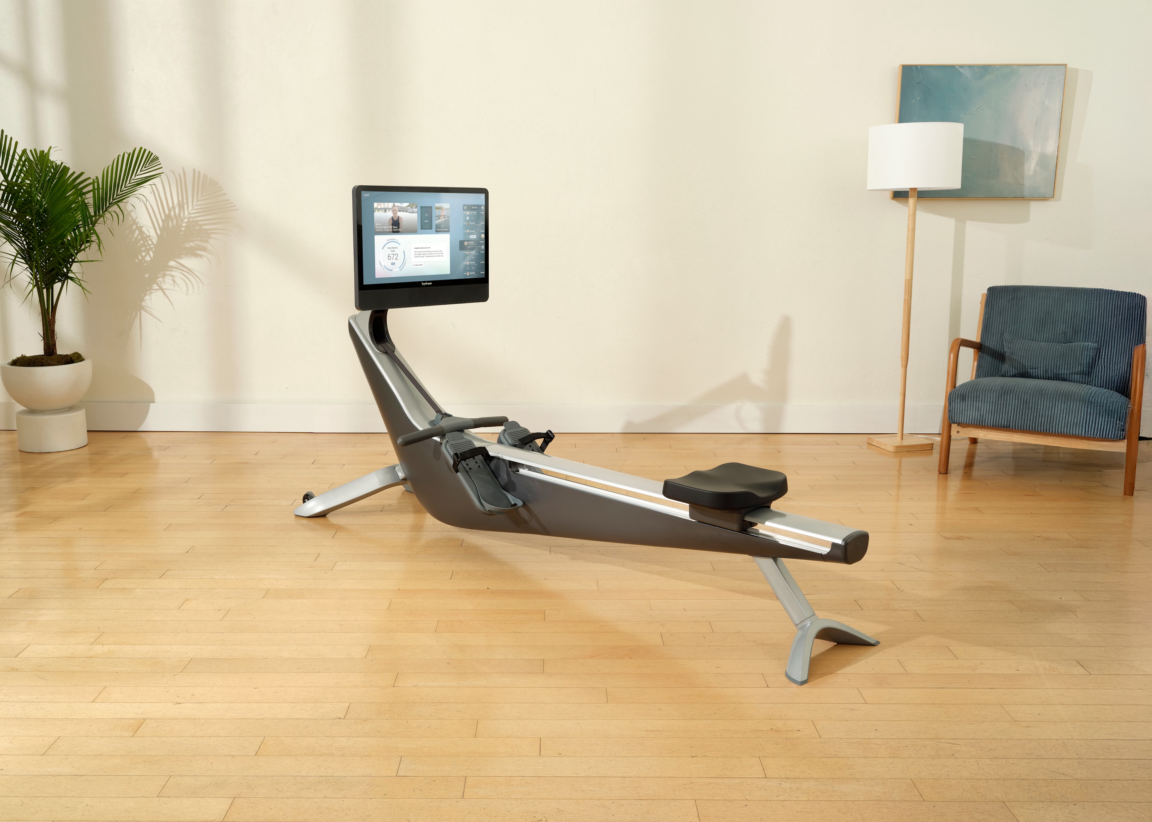 Hydrow rower in a home living room with the HydroMetric Index visible on screen