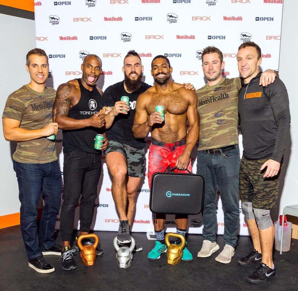 Matt Bean with trainers and staff at the Men's Health Open fitness competition step-and-repeat